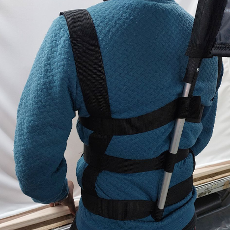 Branded pop-up backpack example of the banner attached to a man with a blue shirt back view