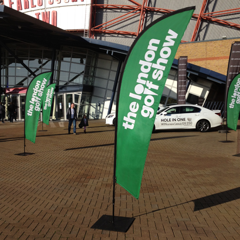 Branded pop-out Finn flag banners outside a stadium in green colour advertising the London Golf Show